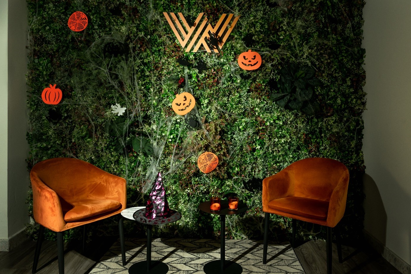 two armchairs with the WIS logo in the background with Halloween decorations