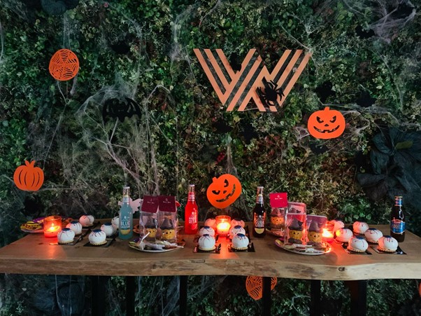 table of sweets with WIS logo in the background